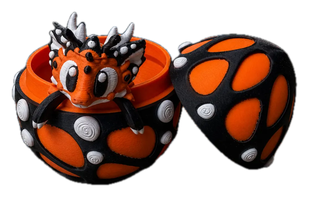 Vlinder draak met ei: zwart drakenei met oranje patronen en witte details, met draak